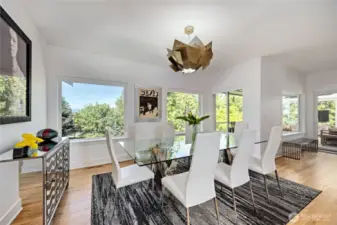 The beautiful dining room offers beautiful West-facing views. The walls and lighting were designed to highlight your art and  furnishings.