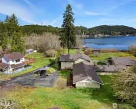 Sitting right on the edge of Summit Lake. The main home is in the center of this photo, with the attached studio apartment on the far right. All of the buildings have addresses on Summit Lake Shore Rd. NW. The main home is 401. The attached studio apartment is 403. The one bedroom home in the left of this photo is 345. There is a cabin not visible in this photo but just beyond the one bedroom home is 347, and the cabin in the distance on the left is 349.