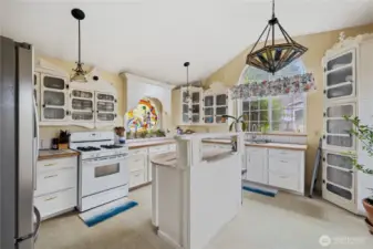 Main home kitchen with propane gas stove & island with granite counters. All five of the units on the property have propane.