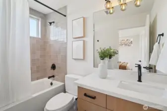 bedroom #1 with full bath including designer tile and quartz countertop