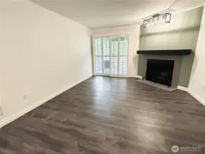 Living room w/slider to the patio. Accent wall with overhead lightling
