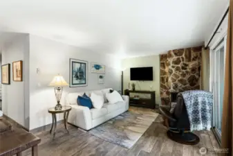 Living room with cozy natural stone fireplace for chilly evenings.