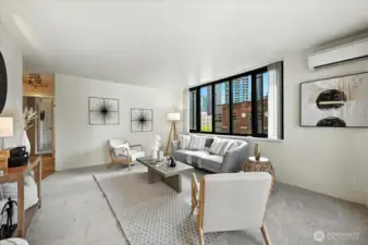 Large living room with natural light and city views from every window.