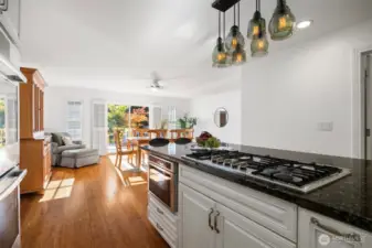 The spacious dining area is filled with natural light and opens right to the back deck. Gas cook top, double ovens, and a built-in microwave top the list for this chef's kitchen.