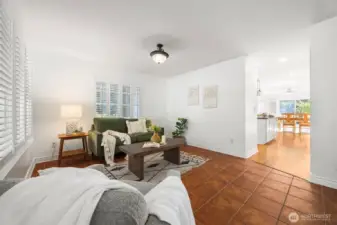 View from the entry way, leading into the kitchen & dining. This sitting/living room is open and spacious.