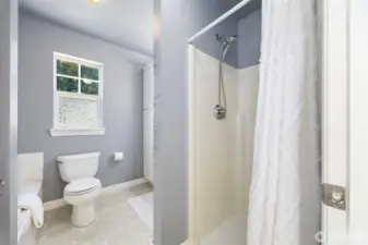 The ensuite off the primary bedroom with it's stall shower & soaking tub.