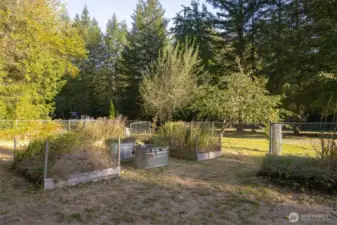 The garden space offers raised garden beds, and is fully fenced-in providing protection from furry friends. The entire property is also fully fenced in.