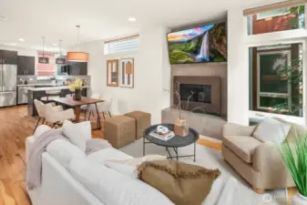 Open concept living/dining/kitchen w/ gas fireplace & floor to ceiling windows