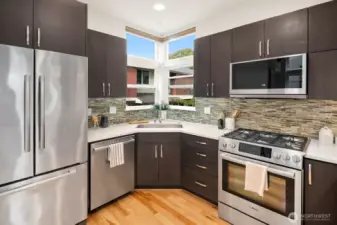 Open concept living/dining/kitchen w/ gas fireplace & floor to ceiling windows