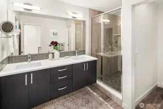 Upper level primary suite w/ walk-in closet & expansive en-suite bath