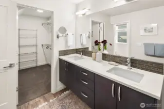 Upper level primary suite w/ walk-in closet & expansive en-suite bath