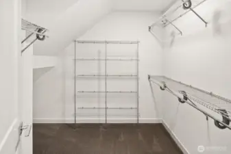 Upper level primary suite w/ walk-in closet & expansive en-suite bath