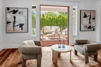 Gorgeous French Doors lead off the Great Room to your private Ipe deck surrounded by gorgeous landscaping and a flowing fountain.