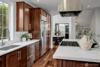 Designer Quartzite stuns in this gorgeous luxury kitchen with an abundance of features! State-of-the-Art appliances for the discerning host including Fisher & Paykel double ovens and dishwasher drawers, 6-burner range with dramatic stainless hood and large single basin sink with retractable brushed nickel faucet and modern hardware elevate this space.