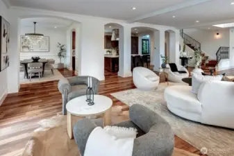 Luxury kitchen and dining room are framed by elegant architectural columns that define the spaces while preserving the effortless flow.