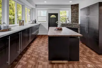Get excited by this fantastic flex room perfect for a Butler's Pantry, Prep Kitchen or Office with its own entry! Features custom storage and butcher block desk/island!