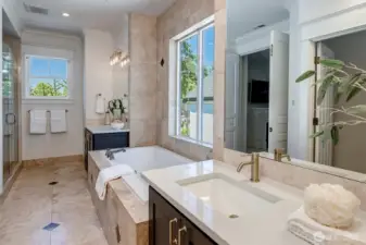 Indulge in the spa-inspired 5-piece en suite designed for ultimate relaxation. Step onto the heated floors and enjoy the beautiful designer quartz counters accented by luxe brass fixtures elevating the space with timeless sophistication.