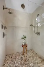 Indulge in the spa-inspired 5-piece en suite designed for ultimate relaxation. Step onto the heated floors and enjoy the beautiful designer quartz counters accented by luxe brass fixtures elevating the space with timeless sophistication.