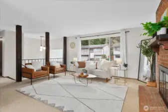 Main living room with view of stairs leading to front door.