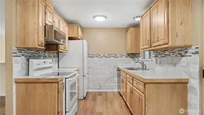 Galley style kitchen with natural toned cabinetry.