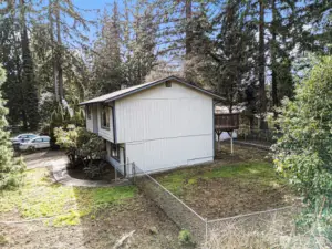 Another view of the backyard showcasing its spacious layout and lush greenery.