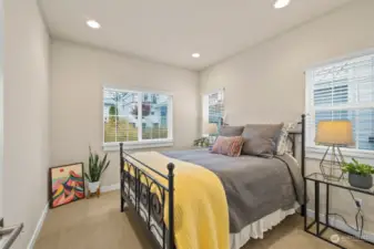 Main level bedroom just off the entrance to the home. Wood faux blinds allow for privacy when needed.