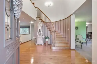 Beautiful hardwood floor and grand staircase in entry way