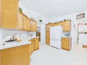 This spacious kitchen has lots of storage and work spaces.