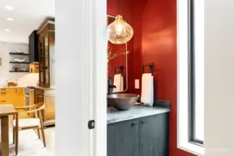 Main floor powder room. Soapstone counter and copper sink with new lighting.
