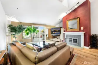 Large living room with high ceilings and wood burning fireplace!