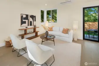 The living room sits just off the kitchen and dininag areas. In this photo, to the right is the sliding wall that opens out to the fully fenced level backyard area and patio.