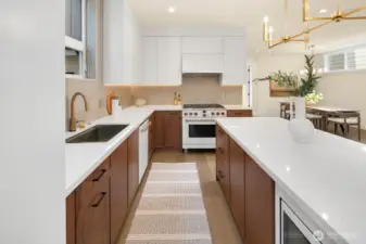 Tow-tone cabinets in white and warm wood create visual interest, depth and a focal point.