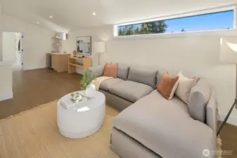 The family room on the top level of the home has a wetbar and access to a covered private deck area.