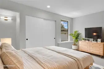 Second bedroom on the upper level with a niche perfect for a desk or vanity. Virtually staged.