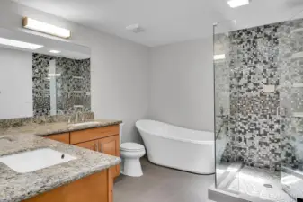 Guest bath with dual sinks, large soaking tub, heated tile floors, and a spacious walk-in shower!