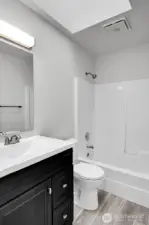 The ADU features a full bathroom with a skylight, providing ample natural light.