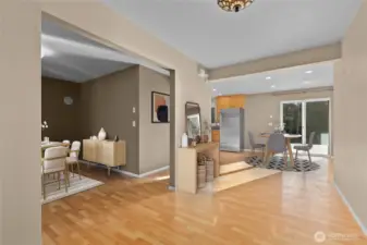 Generous entry space with kitchen, eating area, and great room in the background (virtually staged).