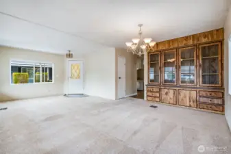 The dining area is open to the living room with a hallway to the rest of the home.