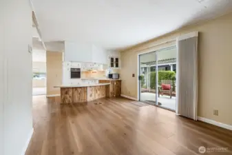 A large family room is adjacent to the kitchen and has a large door out to the covered patio.