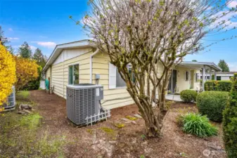 The back yard holds the heat pump unit for efficient cooling and heating!