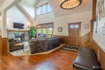 Main floor open concept entry & living room with vaulted ceiling and gas fireplace.