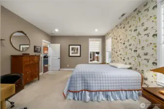 Spacious primary bedroom with upgraded carpet and custom shades.