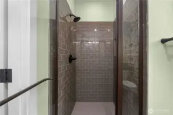 Fully tiled guest shower with upgraded (thicker) glass door.