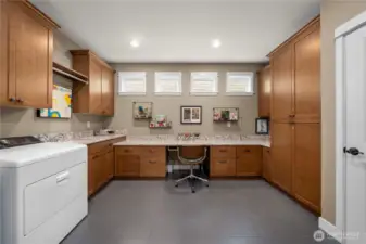 The popular Smart Space offers the perfect space for a workspace, crafting or hobbies!  Also the laundry/mud room with an undermount utility sink.  The washer and dryer which stay with the home.  Tons of storage space as well.