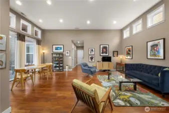 Large great room with gorgeous Engineered hardwoods, tall ceilings and tons of natural light.