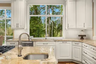 Gorgeous, spotless, expanded and remodeled Chef's kitchen ~ granite counters, huge island, eating bar, 6-burner Wolfe range, double ovens, SubZero fridge and abundant cabinet & counter space.