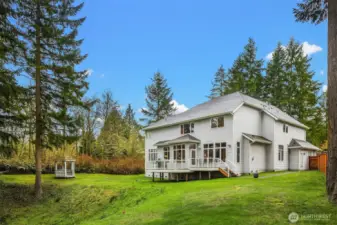 The back yard offers the home with its own outdoor/yard space, and the native growth provides a privacy buffer to the community park.