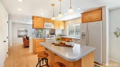 Functional island adds versatility for cooking, dining, or gathering.