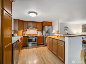 Solid oak cabinets and stainless steel appliances adorns this lovely kitchen.