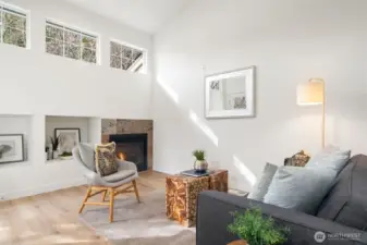 Recreation room with gas fireplace off kitchen with door to patio.